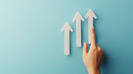 Aufkleber - Hand touching rising graph arrow growing up on blue background, business or financial stock market business concept with hand pointing at upward arrows