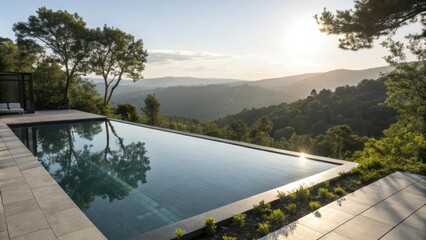 Poster - Modern infinity pool reflecting lush trees and overlooking a serene green valley at sunset, creating an atmosphere of luxury and relaxation in a tranquil outdoor setting
