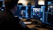 © underground - Officer monitoring multiple screens in a control room.