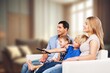 © BillionPhotos.com - Family, mom dad with child watching a TV