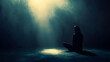 © cynz - A person sitting under a single glowing light, their shadow growing smaller as the light intensifies
