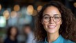© tuiphotoengineer - Confident and Successful Young Professional Woman with Curly Hair and Eyeglasses Smiling Happily in Modern Office Environment