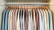 © Vic - Organized closet featuring neatly hung shirts in various colors and patterns with wooden hangers