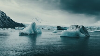 Poster - A serene view of icebergs floating in a cold, tranquil sea under a moody sky.
