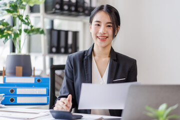 Wall Mural - Business asian woman working at office with documents on desk, doing planning analyzing the financial report, business plan investment, finance analysis concept	
