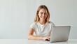 © Krasavina Alena - Smiling woman working on laptop, casual style, white background