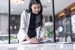 © Charlie's - Beautiful confident asian business woman Auditor or internal revenue service staff, Business women checking annual financial statements of company. Audit Concept.