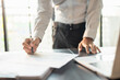 © Charlie's - Close up of businessman hands signing or writing document paperwork and report Auditor analysis male professional hand making notes with Business Document.