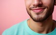 © hakule - man with casual t-shirt is smiling at the camera, solid color background