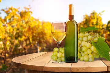 Wall Mural - A glass of wine on a table at vineyard background