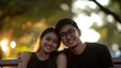 © milenialdesastudio - Couple smiling with warm sunset light in background.