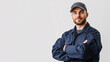 © VT Studio - portrait of a confident mechanic wearing a blue work uniform and a gray cap against a white background