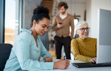 Multiracial coworkers analyzing charts and working together showing teamwork diversity and inclusion