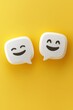© grey - Two cute white speech bubbles with happy face emojis on a yellow background