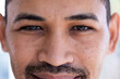 © Wavebreak Media - Close up of portrait of happy man with freckles on face, dark eyes, beard and moustache