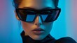 © Andrii Savchuk - Stylish woman with black sunglasses posing in blue neon light