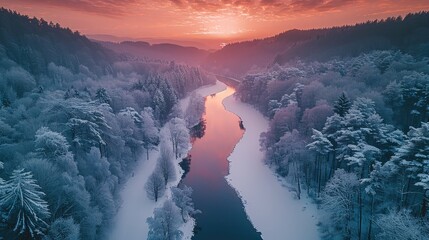 Poster - Aerial view of the frozen river in winter, surrounded by white snow and a red sunset sky, with dense forests on both sides. The trees, covered thickly under heavy snow.