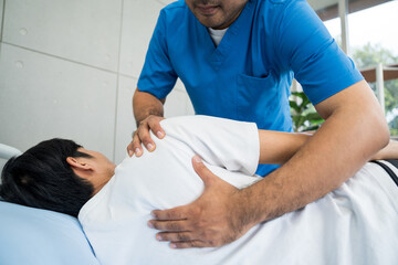 Physical therapy. Male Nurse aids young man in recovering from spine injury and providing orthopedic massage Orthopedic healthcare and chiropractor with person for physical therapy rehabilitation