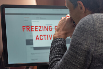 Poster - Upset young man using online banking service and having problem with blocked credit card. Man at computer monitor, stressed about account freeze and blocking issues, searching for solutions
