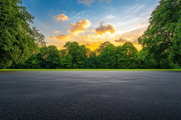 Canvas Print - A deserted asphalt road winding through a lush green forest at sunrise.