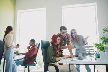 Portrait of five young successful colleagues discuss project drink coffee workplace business center office indoors