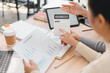 © PRIME STOCK LAB - Business team analyzing financial report with calculator