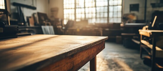 Poster - Vintage wooden desk in a sunlit workshop creating a warm ambiance with ample space for decorative items and artistic inspiration.