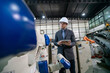 © FotoArtist - Engineer Inspecting Industrial Robots in a Manufacturing Facility