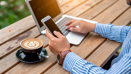 Poster - a person using a phone and a cup of coffee with a coffee cup on the table