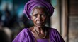 © sevenSkies - African elderly woman serious wearing purple dress looking on camera