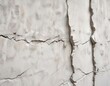 © Sayfar - Close-up shot of white wall with visible cracks and chipping, cracking wall, weathered material, broken plaster, damaged exterior
