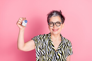 Wall Mural - Portrait of pretty aged lady hold apartment key wear zebra print shirt isolated on pink color background