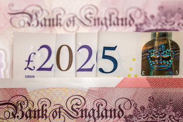 Wall Mural - 2025 in British pounds. UK banknotes arranged in date 2025, Concept, financial and economic analysis of Great Britain. British money. closeup