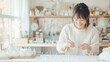 © -SAYONARA- - 手作りアクセサリーに取り組む笑顔の女性