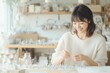© -SAYONARA- - 笑顔でハンドメイドアクセサリーを制作する女性