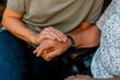 © Maskot - Female nurse consoling elderly woman sitting on bench