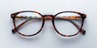 © marimalina - Stylish tortoiseshell eyeglasses displayed on a clean surface, highlighting their unique pattern and modern design for fashion enthusiasts