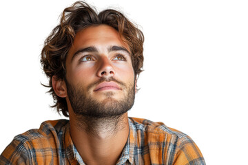 A young man gazes thoughtfully upwards, with a relaxed expression, wearing a casual plaid shirt. Isolated on a clean white background.