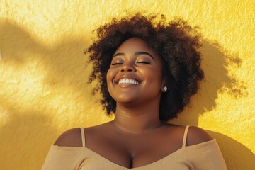 plus size african american confident smile woman with curly black near yellow wall. overweight black