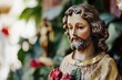 © Fotograf - A statue of Jesus Christ holding a rose in his hand, a symbol of love and devotion