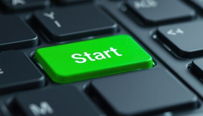 closeup view of green start button on black computer keyboard. modern tech interface element highlig