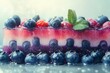 © Victor Bertrand - A vibrant berry and layered dessert topped with fresh mint leaves glistens with freshness, promising a delightful burst of flavor.