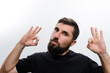 © Niko_Dali - A bearded man against a white background gestures with both hands forming the 'OK' sign, indicating approval or agreement.