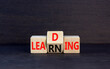 © Dzmitry - Learning or leading symbol. Concept words Learning Leading on wooden block. Beautiful black table black background. Business learning or leading concept. Copy space.