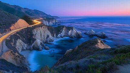 Wall Mural - Coastal highway at sunset, light trails on winding road along dramatic cliffs and ocean.