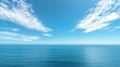 Serene ocean panorama with blue skies and wispy clouds