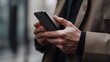 © AN STOCK - Concept of a newsletter Hand of a businessman checking a message box on his smartphone