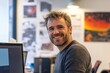 © Maelgoa - Confident man in a startup office, smiling while discussing a new project with colleagues, surrounded by tech-related posters and a vibrant, innovative atmosphere 4