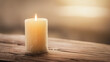 © Bonsales - Burning candle on a rustic wooden table with warm light creating a serene and peaceful atmosphere