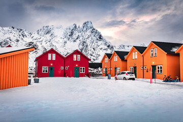 Wall Mural - typical norwegian wooden houses in ballstad town on the shore of norwegian sea. gloomy morning scene